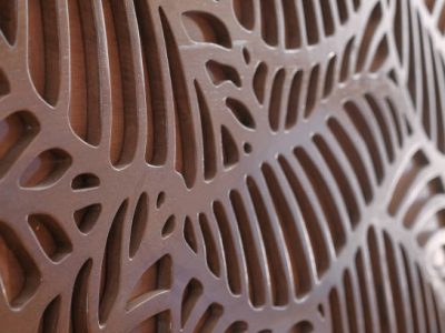 istockphoto-1389128866-612×612 Close up finished teak wooden door engraving grooved texture by CNC laser machine. Selective focus.